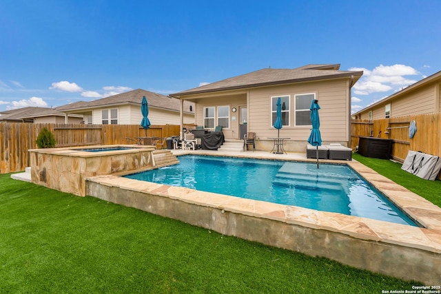 view of pool with a fenced backyard, an in ground hot tub, a lawn, a fenced in pool, and a patio area