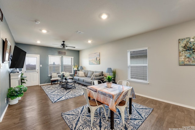 living area with recessed lighting, visible vents, baseboards, and wood finished floors