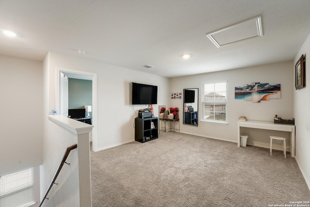 interior space with attic access, visible vents, baseboards, carpet, and recessed lighting