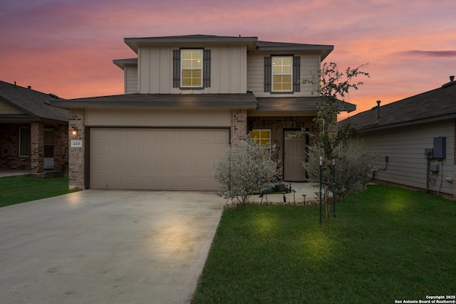 view of front of home with a garage, brick siding, concrete driveway, a lawn, and board and batten siding