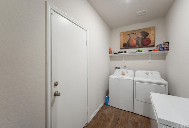 washroom featuring laundry area, visible vents, wood finished floors, independent washer and dryer, and a sink