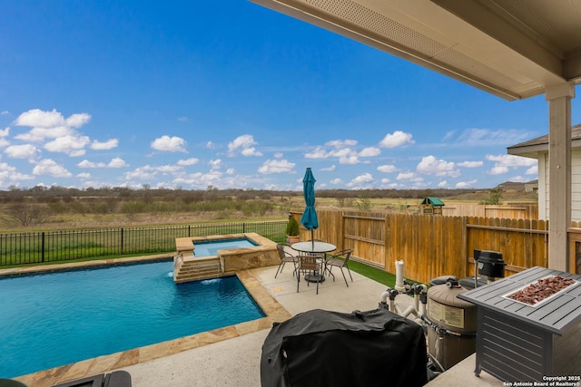 view of swimming pool with a patio, a fire pit, an in ground hot tub, area for grilling, and a fenced in pool