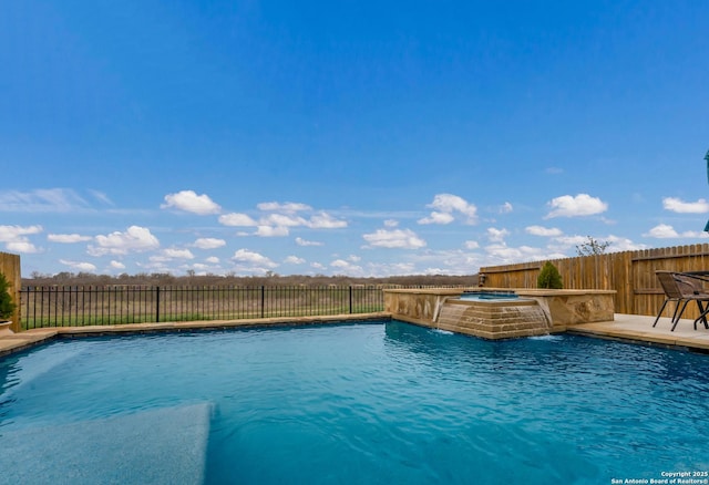 view of swimming pool featuring a fenced in pool, a fenced backyard, and a jacuzzi