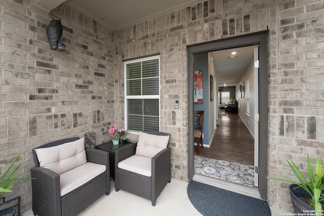 doorway to property with brick siding and outdoor lounge area