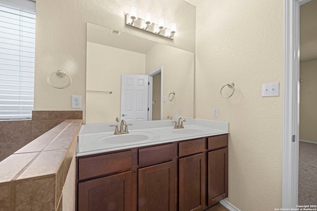 full bathroom with double vanity, a sink, and visible vents