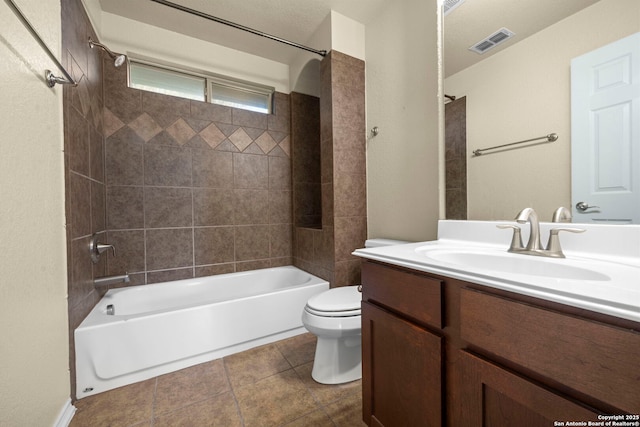 full bathroom featuring bathtub / shower combination, visible vents, toilet, vanity, and tile patterned floors