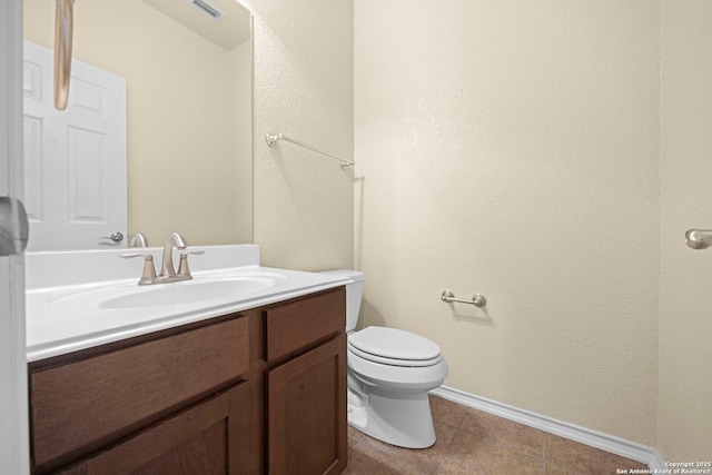 half bathroom featuring tile patterned flooring, toilet, visible vents, vanity, and baseboards