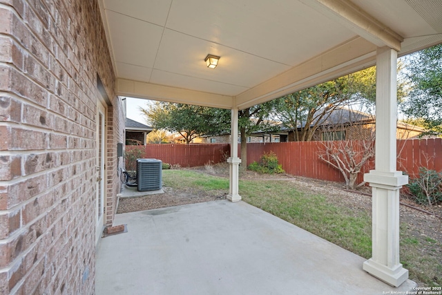 view of patio / terrace with central AC and fence