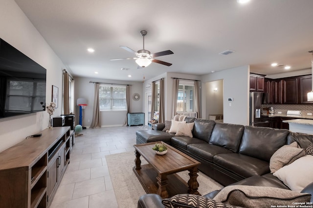 living area featuring light tile patterned floors, ceiling fan, visible vents, and recessed lighting