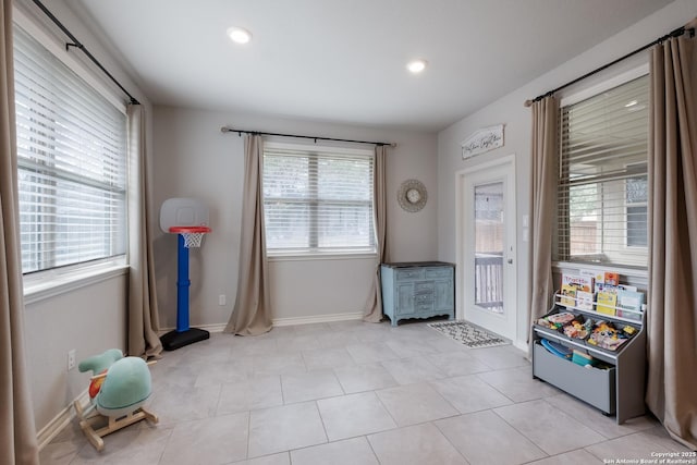 rec room featuring baseboards, recessed lighting, and a healthy amount of sunlight