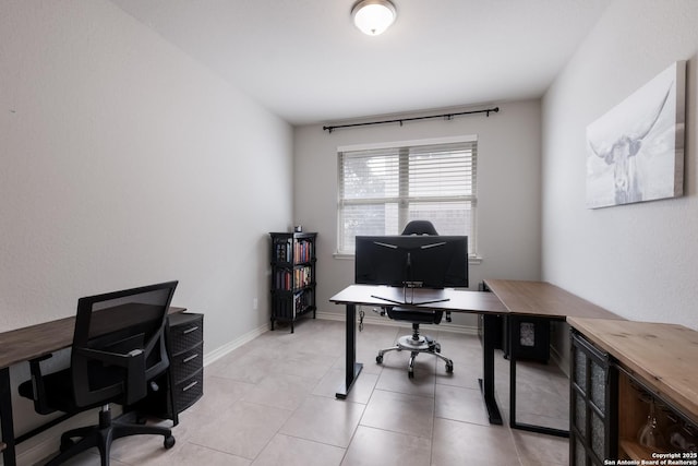 office featuring light tile patterned floors and baseboards