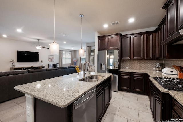 kitchen featuring appliances with stainless steel finishes, open floor plan, visible vents, and a sink