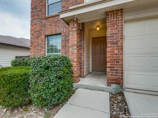 doorway to property with brick siding