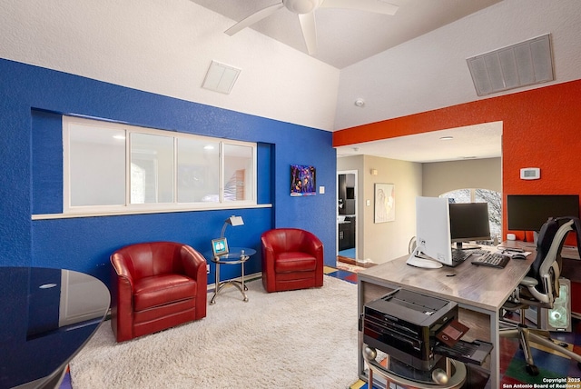 office space with a textured wall, carpet floors, and visible vents