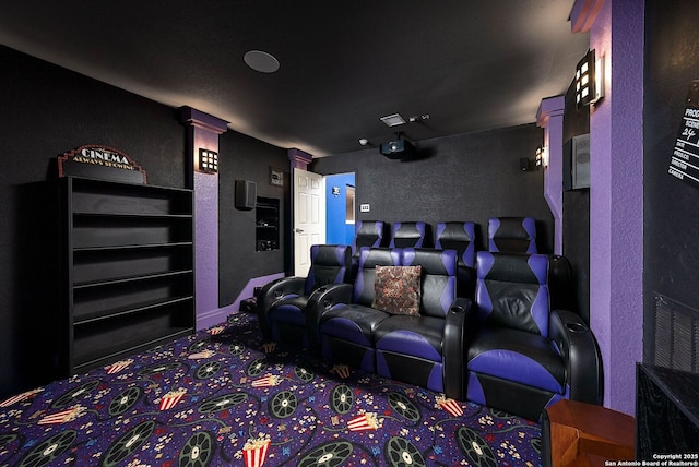 carpeted cinema with a textured wall and decorative columns