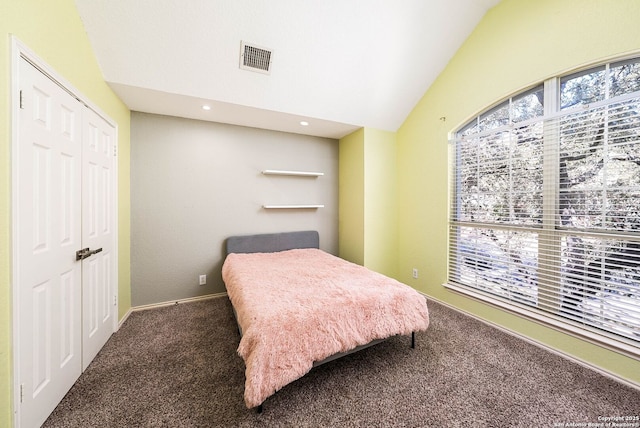 bedroom with visible vents, vaulted ceiling, and carpet flooring