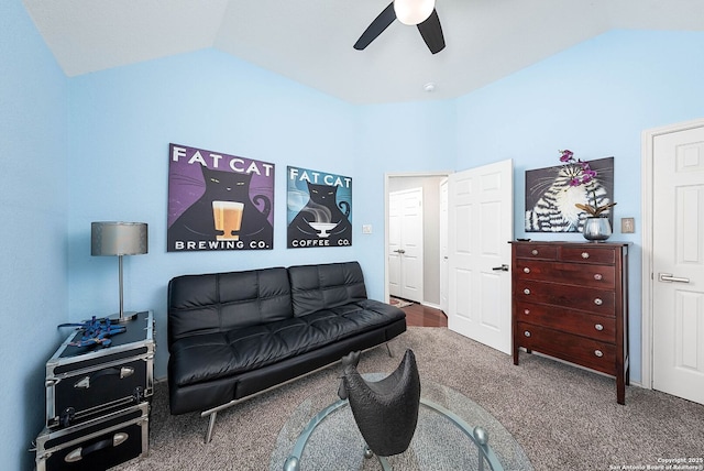 living area featuring carpet flooring, vaulted ceiling, and ceiling fan