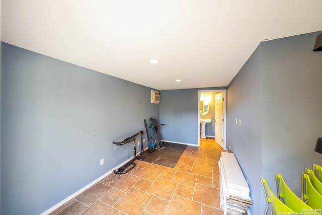 workout room featuring recessed lighting, a wall unit AC, baseboards, and light tile patterned flooring