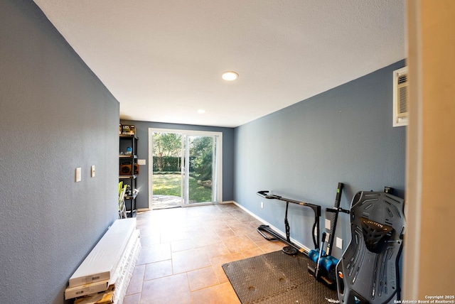 workout area featuring tile patterned flooring and baseboards