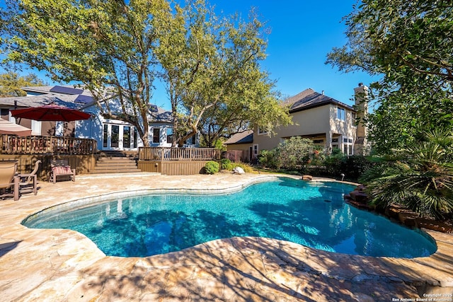 pool featuring a patio and a wooden deck