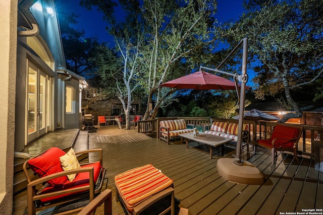 deck at twilight with an outdoor hangout area and french doors