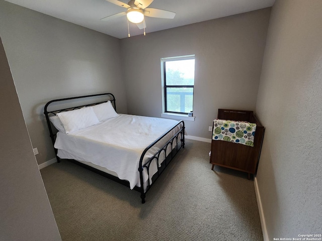 carpeted bedroom with a ceiling fan and baseboards