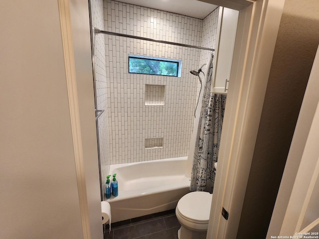 bathroom featuring tile patterned flooring, shower / tub combo, and toilet