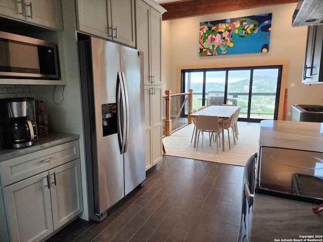 kitchen with appliances with stainless steel finishes and dark wood-type flooring