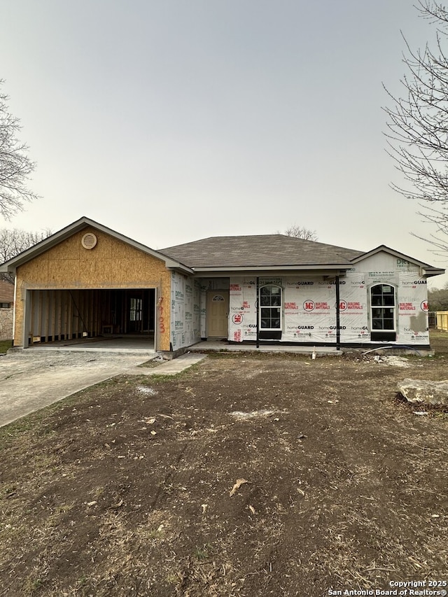 property in mid-construction with driveway and a garage