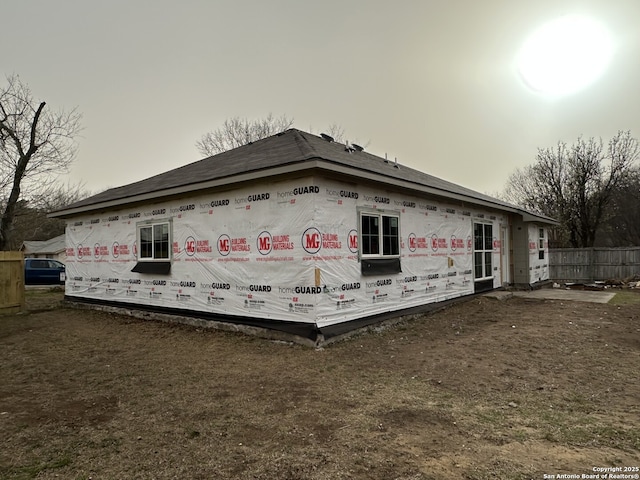 view of side of property featuring fence