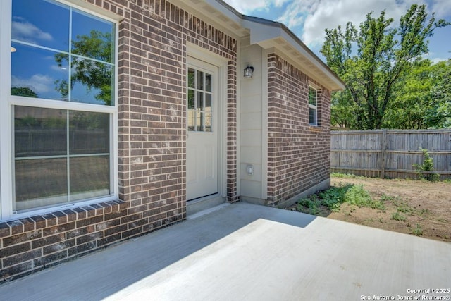 7903 Echo Wind, San Antonio, TX 78250 - entrance to property featuring brick siding and a patio area