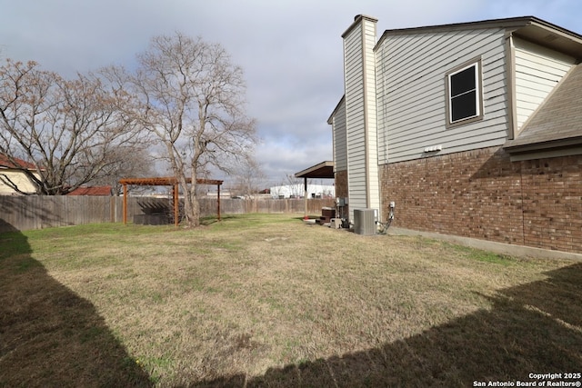 view of yard featuring cooling unit and fence