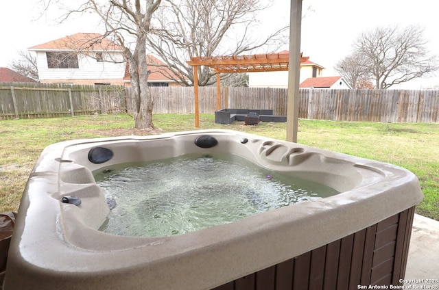 exterior space featuring a yard, a hot tub, and fence