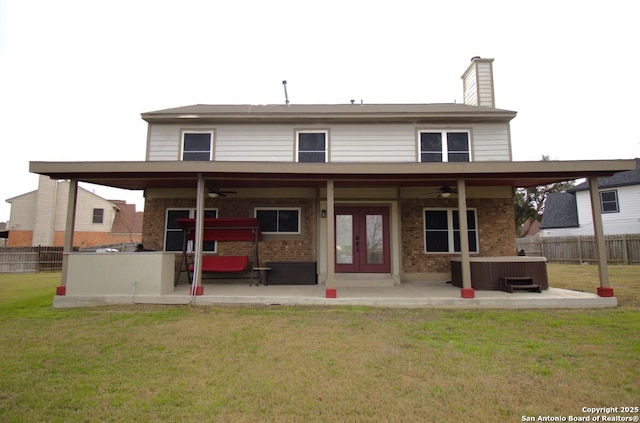 rear view of property featuring brick siding, a patio area, and fence