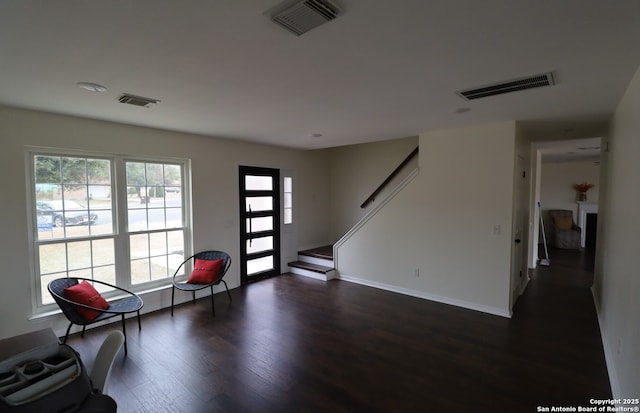 entryway featuring dark wood-type flooring, visible vents, and stairway