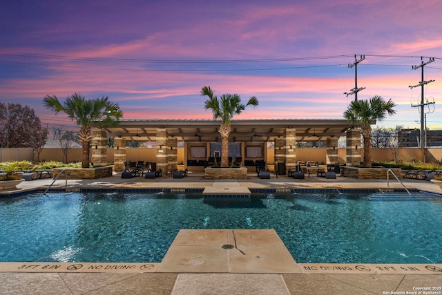 pool featuring ceiling fan, a patio area, and fence