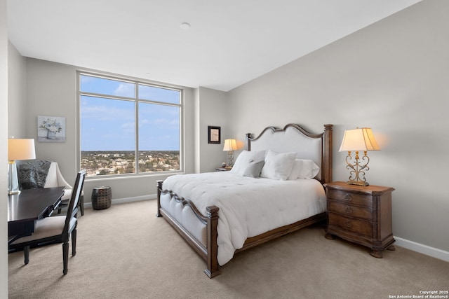 carpeted bedroom featuring baseboards