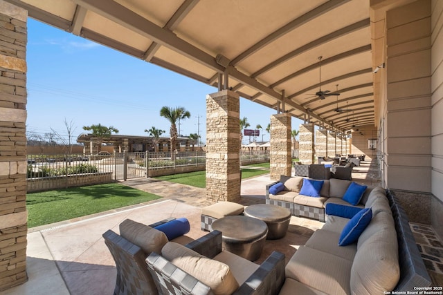 view of patio / terrace featuring a ceiling fan, outdoor lounge area, and fence