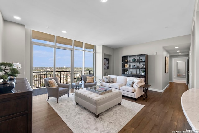 living room with dark wood-style floors, recessed lighting, baseboards, and floor to ceiling windows