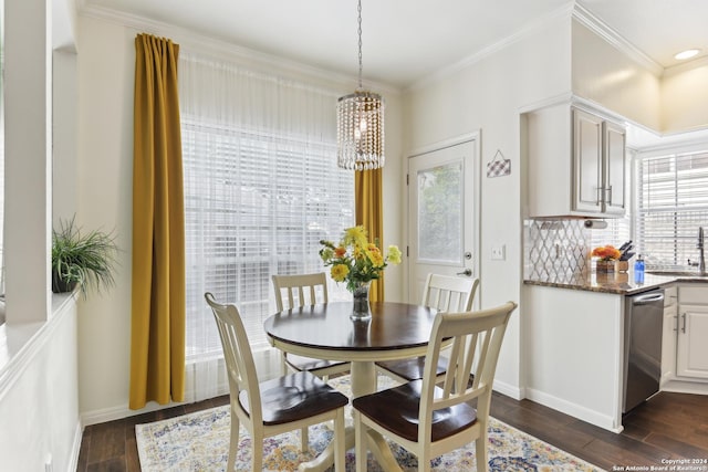 dining room featuring baseboards, dark wood-style flooring, and crown molding