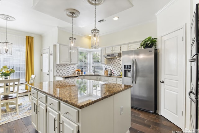 kitchen with under cabinet range hood, wood tiled floor, a sink, and stainless steel fridge with ice dispenser