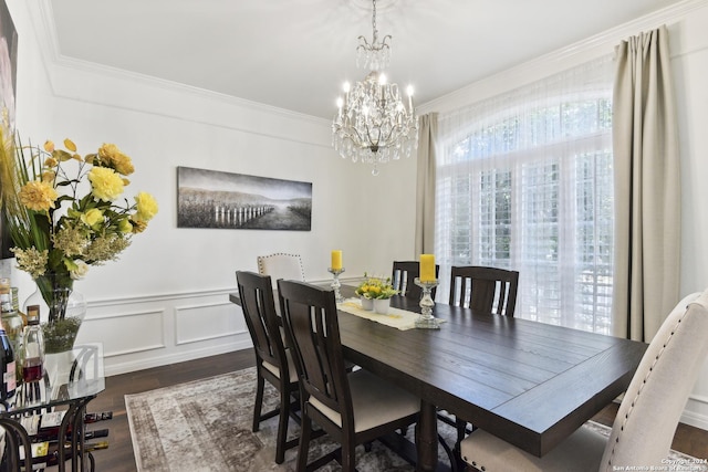 dining space featuring a wainscoted wall, ornamental molding, dark wood finished floors, and a decorative wall