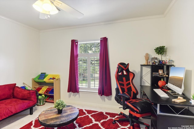 carpeted home office with baseboards, a ceiling fan, and crown molding