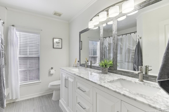 bathroom with toilet, visible vents, ornamental molding, and a sink