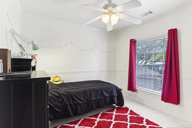 carpeted bedroom featuring ornamental molding, visible vents, ceiling fan, and baseboards