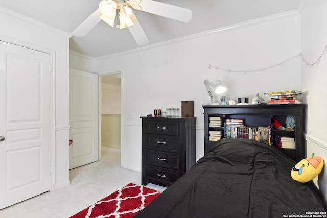 carpeted bedroom with ceiling fan and crown molding