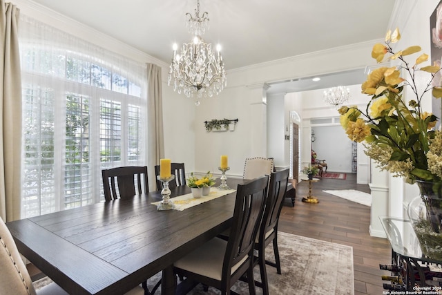 dining space with a chandelier, dark wood-style flooring, and crown molding