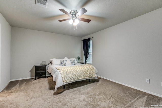 bedroom featuring a textured ceiling, carpet, visible vents, and baseboards