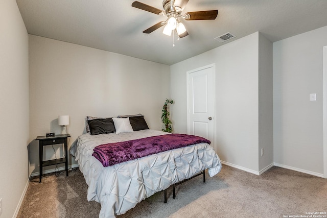 bedroom with ceiling fan, carpet flooring, visible vents, and baseboards