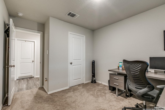 office featuring baseboards, visible vents, and carpet flooring